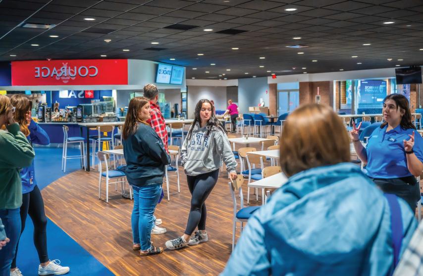 A tour of six people in a cafeteria